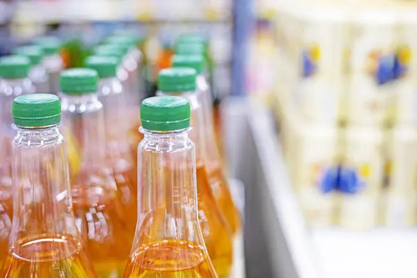 stock image orange drinks in plastic containers on the counter in a supermarket