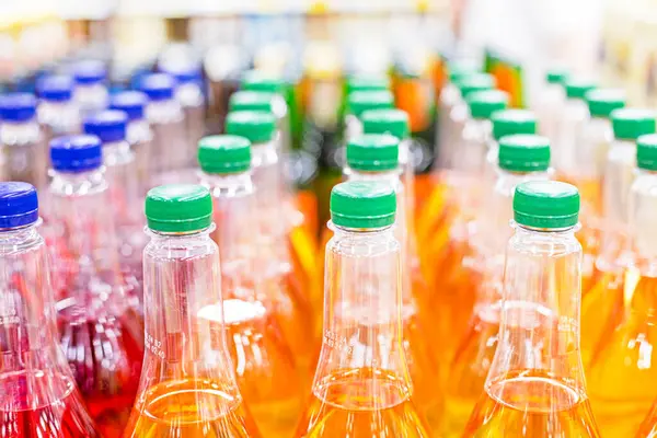 stock image drinks in plastic containers on the counter in a supermarket