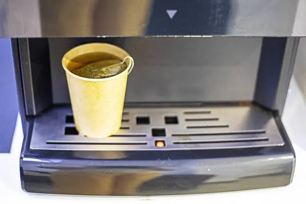 stock image machine with disposable cardboard cup of secondary processing of green tea. Ecology of the environment