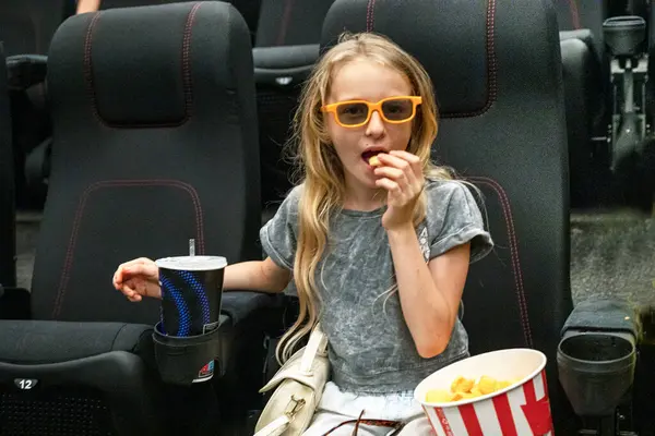 stock image happy girl in three glasses sits in the cinema hall before the screening. Family weekend