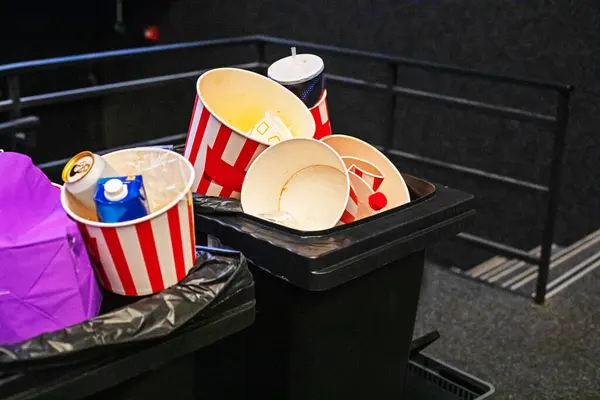 Stock image Throw disposable packaging into the trash after pop-con after a movie show. Family weekend