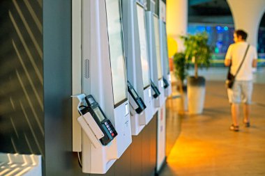 machines for ordering self-service food in the interior of a shopping center clipart