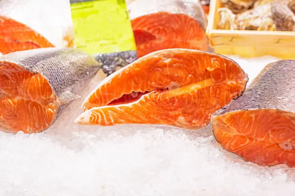 stock image pieces of red fish in ice on the counter in a supermarket