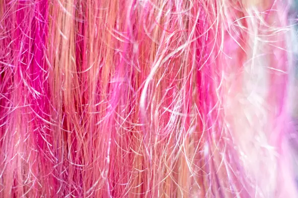 stock image background of bright pink and purple strands of hair. Modern hairstyles