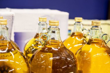 olive oil packaged in glass bottles in a supermarket. Beauty and health care clipart