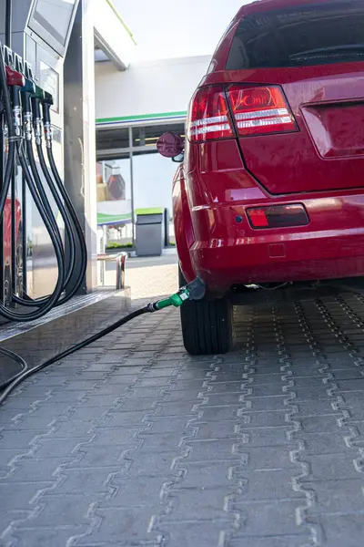 stock image red car at a gas station is refueling with LPG gas. Economic crisis. rising prices for oil and fuel