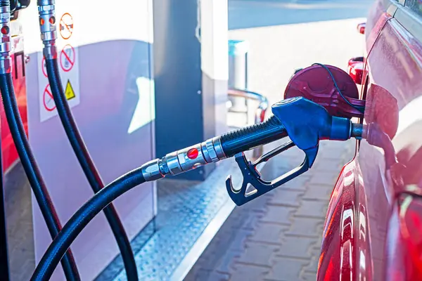 stock image filling up a red car. Global economic crisis and default