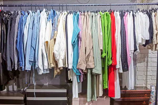 stock image various women's clothing on hangers in the clothing department of a supermarket. casual style