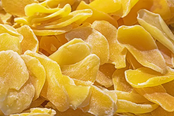 stock image background of dried sweet mango pieces by weight