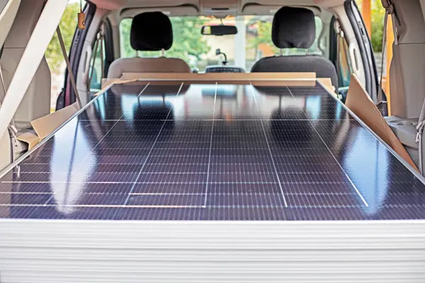 stock image double-sided solar panels in the car. Solar energy economy and the crisis of electric power. blackout