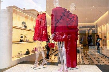 stylish dresses in a clothing store window with visitors in Venice on October 10, 2024 clipart