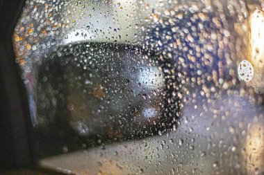 side mirror in raindrops while driving. Poor visibility. traffic safet clipart