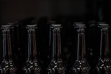 stylish black glass bottles in a supermarket with beer clipart