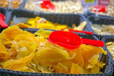 dried mango pieces in a container in a supermarket. Healthy food clipart