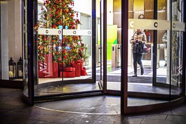 Christmas tree decorated with garlands near the entrance to the office. In anticipation of Christmas and New Year