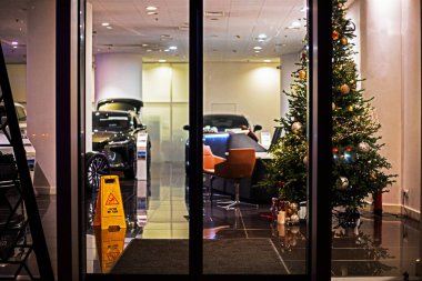 Christmas tree decorated with garlands near the entrance to the office. In anticipation of Christmas and New Year clipart