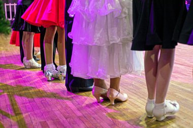 girls in beautiful dresses and shoes at the ballroom dancing tournament clipart