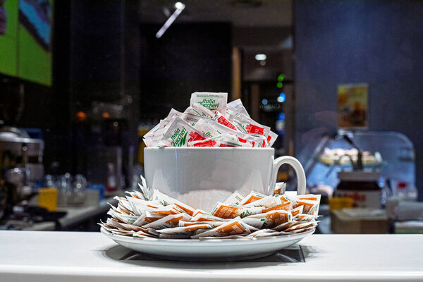 white cup with sugar packets on the bar counter. Everyday life. Traveling around Europe