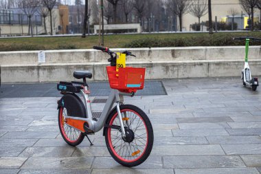 parked bicycle near the bike path in the evening in a rainy city clipart