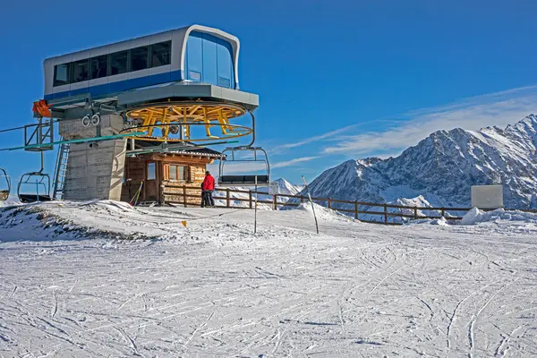 Güneşli bir günde Alplerdeki bir dağın tepesinde kayak asansörü.