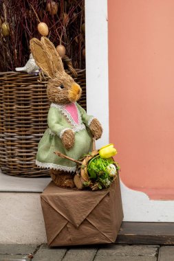 Dışarıdaki pembe arka planda tavşan heykelcikleri. Paskalya tatili
