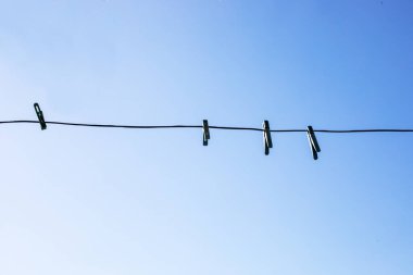 Derin gökyüzüne karşı çamaşır ipinde bir mandal.