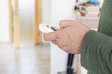 Adam televizyon için uzaktan kumanda tutuyor. modern teknolojiler