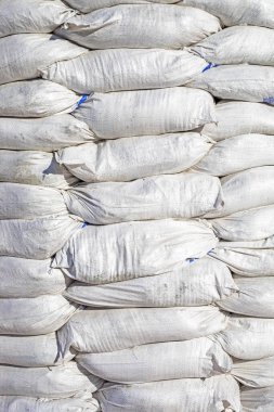 Beyaz kum torbaları üst üste istiflenmiş. Askeri operasyonlar sırasında savunma ve koruma