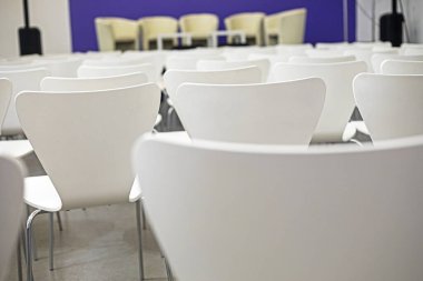 Konferans salonundaki gösteriden önce boş beyaz sandalyeler. eğitim ve geliştirme