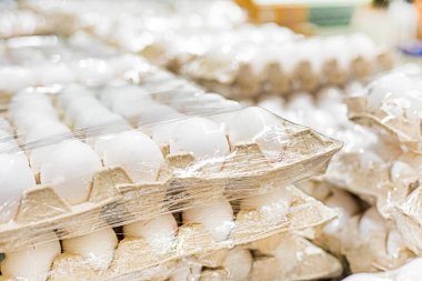 Süpermarketteki karton kaplarda beyaz tavuk yumurtaları. Ekonomik kriz