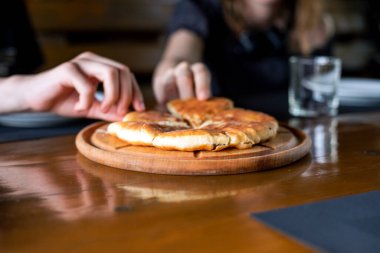 Peynirli khachapuri 'yi ellerinle parçalara ayır.