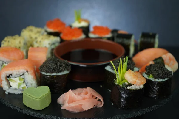 Served traditional Japanese seafood rolls, nigiri, maki, and sashimi