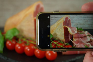 Arrangement of Iberian sliced ham set, delicatessen meat on a plate