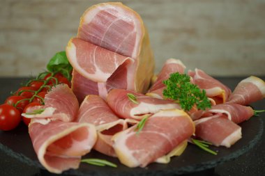 Arrangement of Iberian sliced ham set, delicatessen meat on a plate