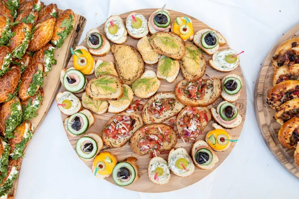 Outdoor catering buffet with a variety of food snacks and appetizers.