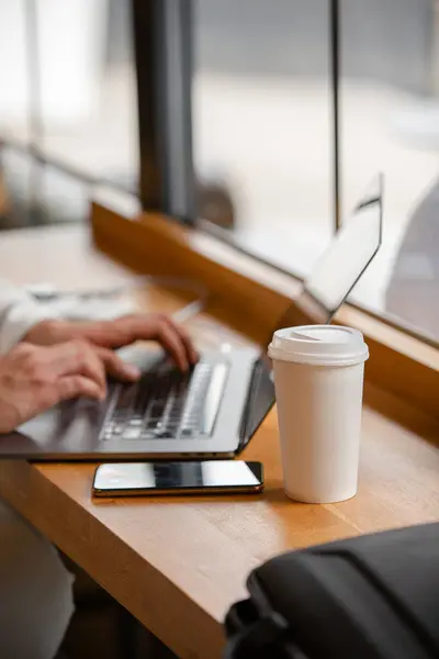 Ofiste dizüstü bilgisayarda çalışan genç adam.