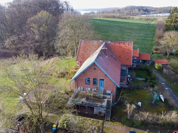 Beautiful house or cottage in the hills spring time. High quality photo.brick house in Germany in the forest. a lot of junk around the house