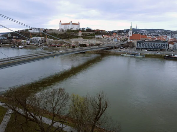 View on Bratislava castle and old town over the river Danube in Bratislava city, Slovakia. High quality photo. Bratislava bridge. Slovakish panorama.