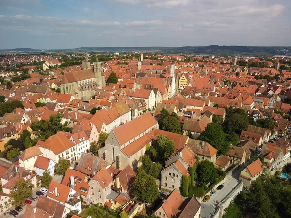 stock image Classic view of the medieval town of Rothenburg ob der Tauber with medieval wall and forest on a beautiful sunny day with blue sky and clouds in springtime, Bavaria, Germany. High quality photo