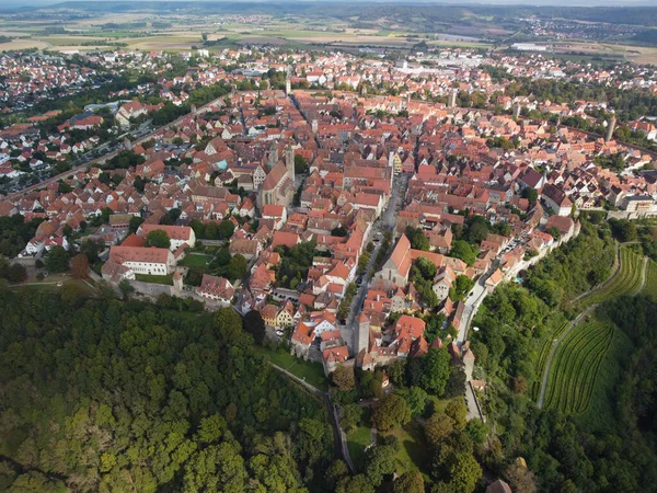 stock image Classic view of the medieval town of Rothenburg ob der Tauber with medieval wall and forest on a beautiful sunny day with blue sky and clouds in springtime, Bavaria, Germany. High quality photo