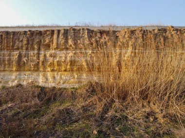 Küçük taşlar ve tozla kaplı sarı ve kahverengi toprak desenli bir arka plan. Kazı kir dokusu açığa çıktı. Yüksek kalite fotoğraf. Bir kaya heyelan, tüm toprak ve taş katmanları görülebilir. kazılar.