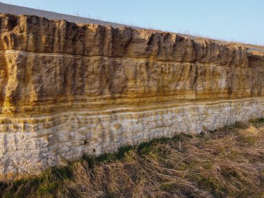 Küçük taşlar ve tozla kaplı sarı ve kahverengi toprak desenli bir arka plan. Kazı kir dokusu açığa çıktı. Yüksek kalite fotoğraf. Bir kaya heyelan, tüm toprak ve taş katmanları görülebilir. kazılar.