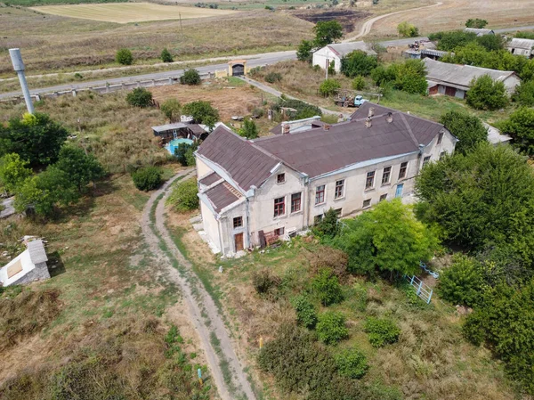 stock image Rural house by the forest in Ukraine.a former estate in the woods. The house is falling apart and old tsarist times. there are fields and trees around. High quality photos 