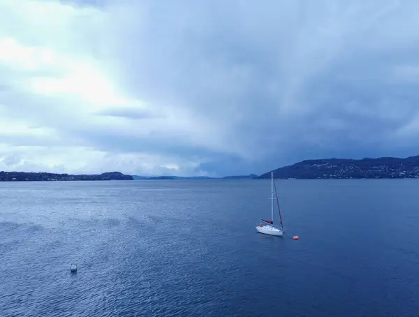 Aerial view of yacht sailing near beautiful Islands. Beautiful clouds in the background. Luxury yacht in the sea. High quality photo