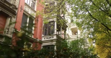 Viewing a old red german building in nice area surrounded by autumn trees. High quality 4k footage