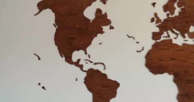 Wooden world map full view pan out, elegant vintage decor, room white wall. High quality 4k footage