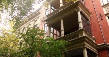 Discovering nice residential area during fall season with red building. High quality 4k footage