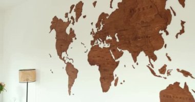 Elegant wooden world map modern room white wall, wall decoration . High quality 4k footage