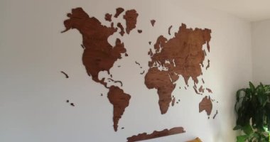 Elegant vintage wooden world map, in modern simple living room white wall. High quality 4k footage