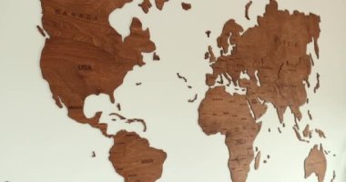 Elegant Wooden World Map Wall Deco in simplistic Modern Room Left to Right. High quality 4k footage